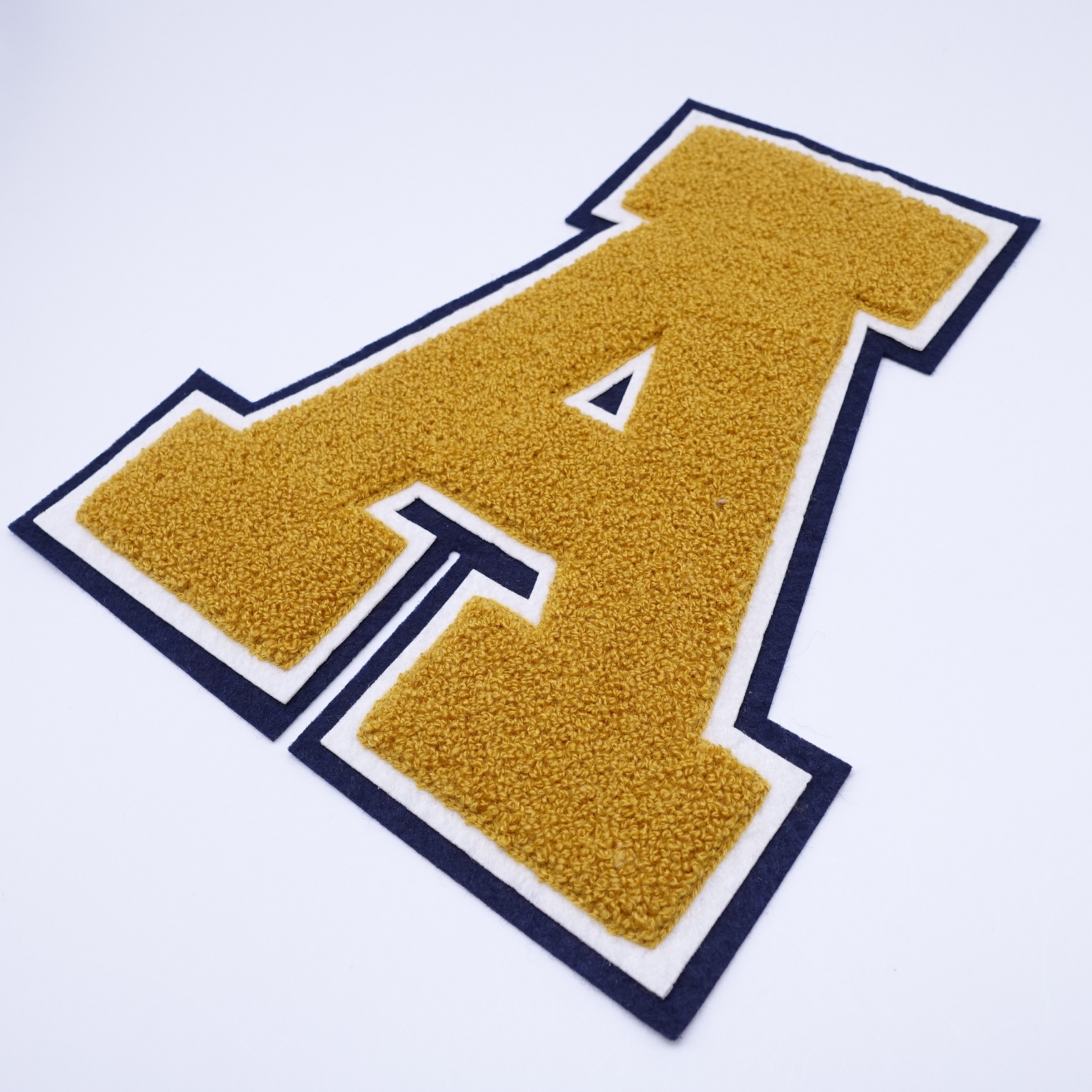 Large chenille letter A with gold chenille yarn black and white double felt border