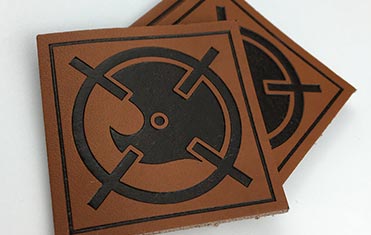 sqaure shaped dark brown custom leather patches with embossed printing