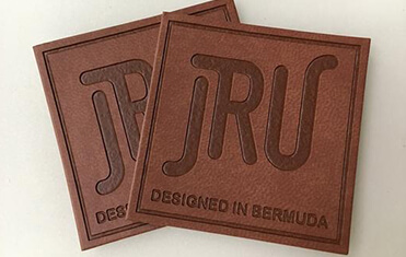dark brown square shaped custom leather patch with border debossing